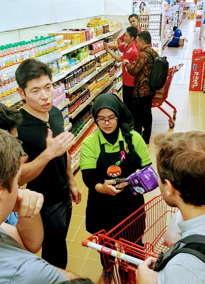 Our CEO, Anthony Tan, picking items for a consumer, on an immersion trip.